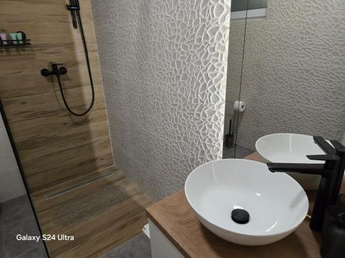 a bathroom with a white toilet and a shower at Apartman AURA self CHECK-IN, FREE PRIVATE PARKING in Osijek