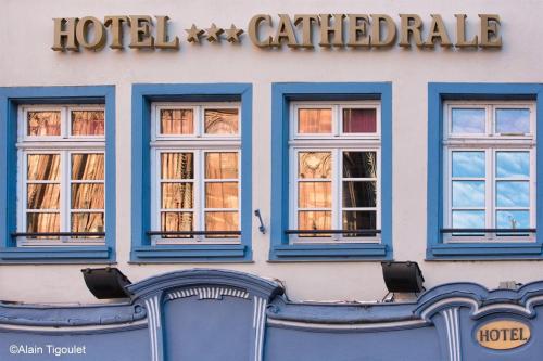 a hotel building with blue windows and a hotel called rake at Hotel Cathédrale in Strasbourg