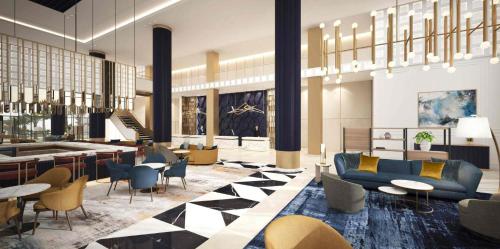 a lobby with couches and chairs and a bar at voco Jeddah Gate, an IHG Hotel in Jeddah