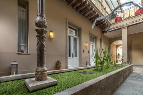 a column in the middle of a courtyard at Patios de San Telmo in Buenos Aires