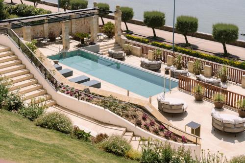 an image of a swimming pool with stairs at Palacio Arriluce Hotel in Getxo