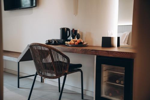 a kitchen with a table and a chair next to a fireplace at Ananea Tropea Yachting Resort in Tropea