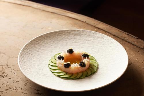 a dessert on a white plate on a table at Hotel & Spa REGENT PETITE FRANCE in Strasbourg