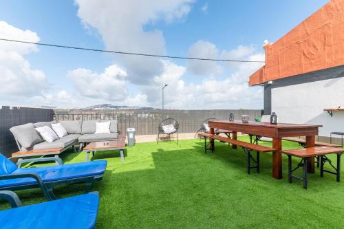 a patio with a couch and a table and chairs at MyPlaceLisbon - Lumiar Luxury House in Lisbon