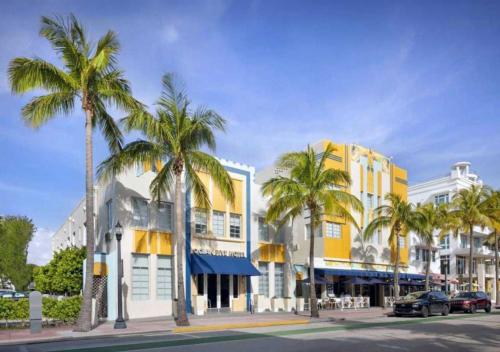 a street with palm trees in front of buildings at South of Fifth Studio Steps to Beach on Ocean Drive in Miami Beach