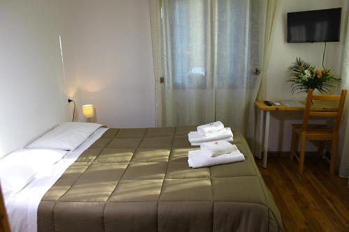 a hotel room with a bed with towels on it at Hotel Al Verde in Mandello del Lario