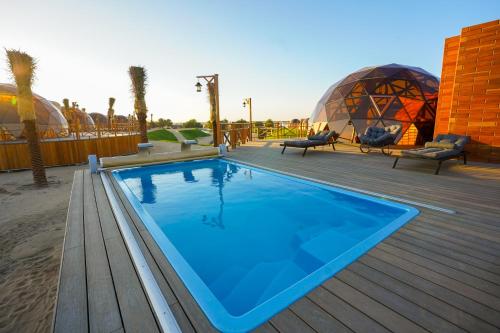 Al Marmoom Oasis "Luxury Glamping & Bedouin Experience" tesisinde veya buraya yakın yüzme havuzu