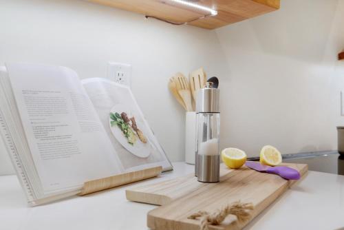 a kitchen counter with a cutting board and a book at The Poe - Stylish Studio in downtown High Springs in High Springs