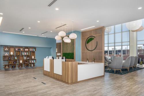 a lobby with a reception desk and chairs at Element Knoxville West in Knoxville