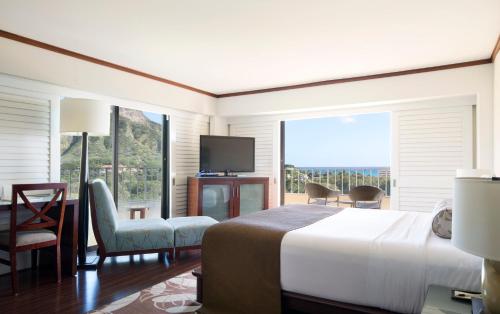 a bedroom with a large bed and a large window at Lotus Honolulu at Diamond Head in Honolulu