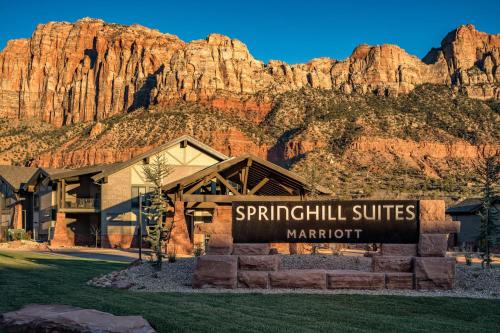 a sign in front of a building with a mountain at SpringHill Suites by Marriott Springdale Zion National Park in Springdale