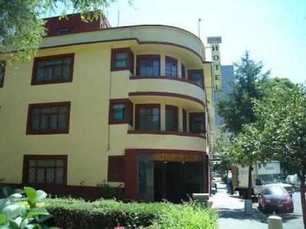 a yellow and red building on the side of a street at Hotel Oxford in Mexico City