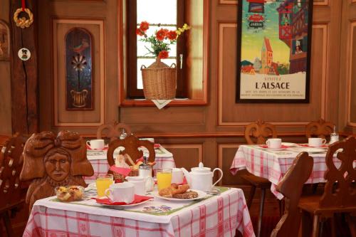 a dining room with two tables with food on them at Hotel Restaurant Père Benoît in Entzheim