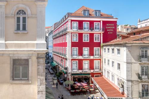 a red building in the middle of a city at Rossio Garden Hotel in Lisbon