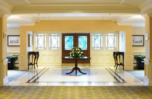 a room with a table with a christmas tree on it at Hollins Hall Hotel, Golf & Country Club in Bradford