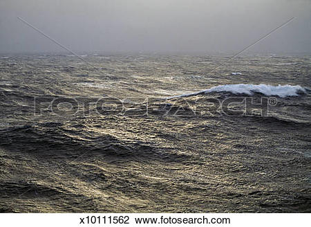 Stock Photo of Pale low sunlight on stormy fog.