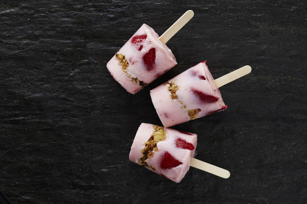 Layer strawberry yogurt, granola (we like this homemade version), and quartered strawberries in Dixie Cups. Top with popsicle sticks and freeze. 