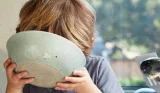 Child Drinking Milk from Bowl