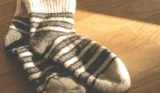 a pair of stripes socks on a wooden surface