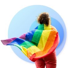 woman with the LGBTIQ flag on her back