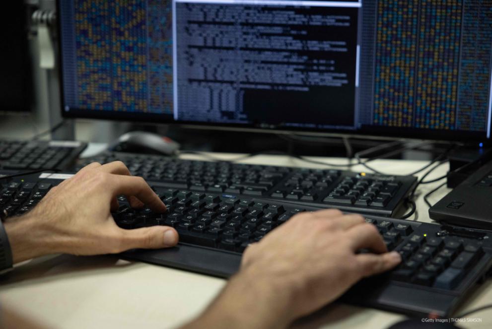 A person monitoring information on a computer.