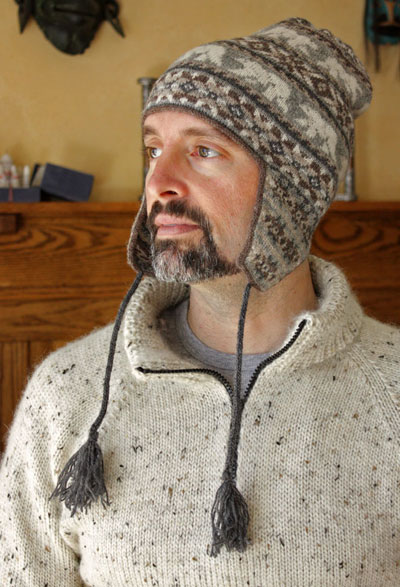 Man wearing knife stocking cap with tassels. 