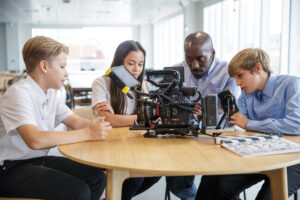 A teacher and students working on a project