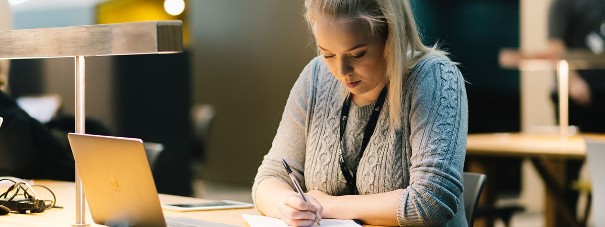 Female student studying at desk