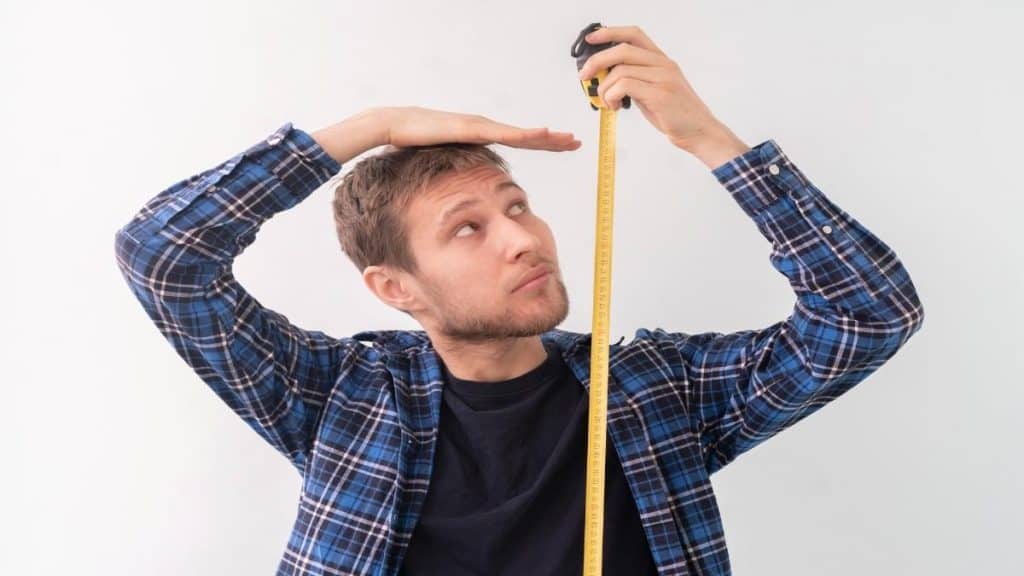 A man holding a tape measure