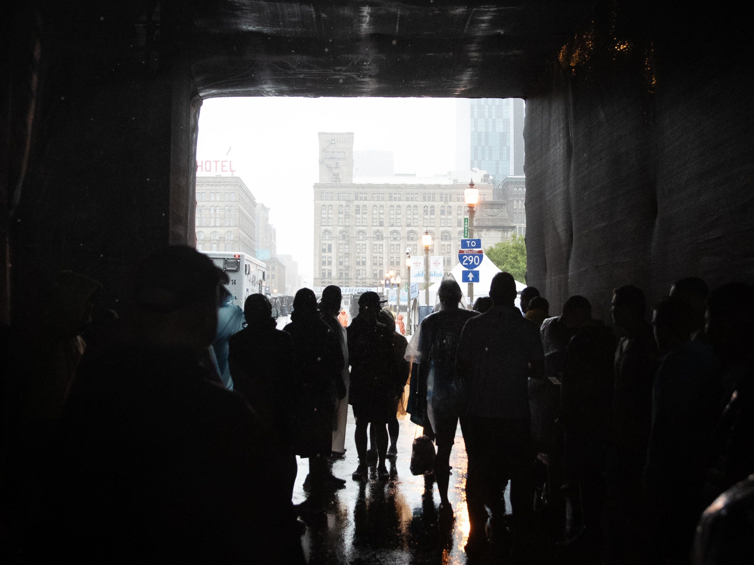 People seek shelter under the Paddock Club.