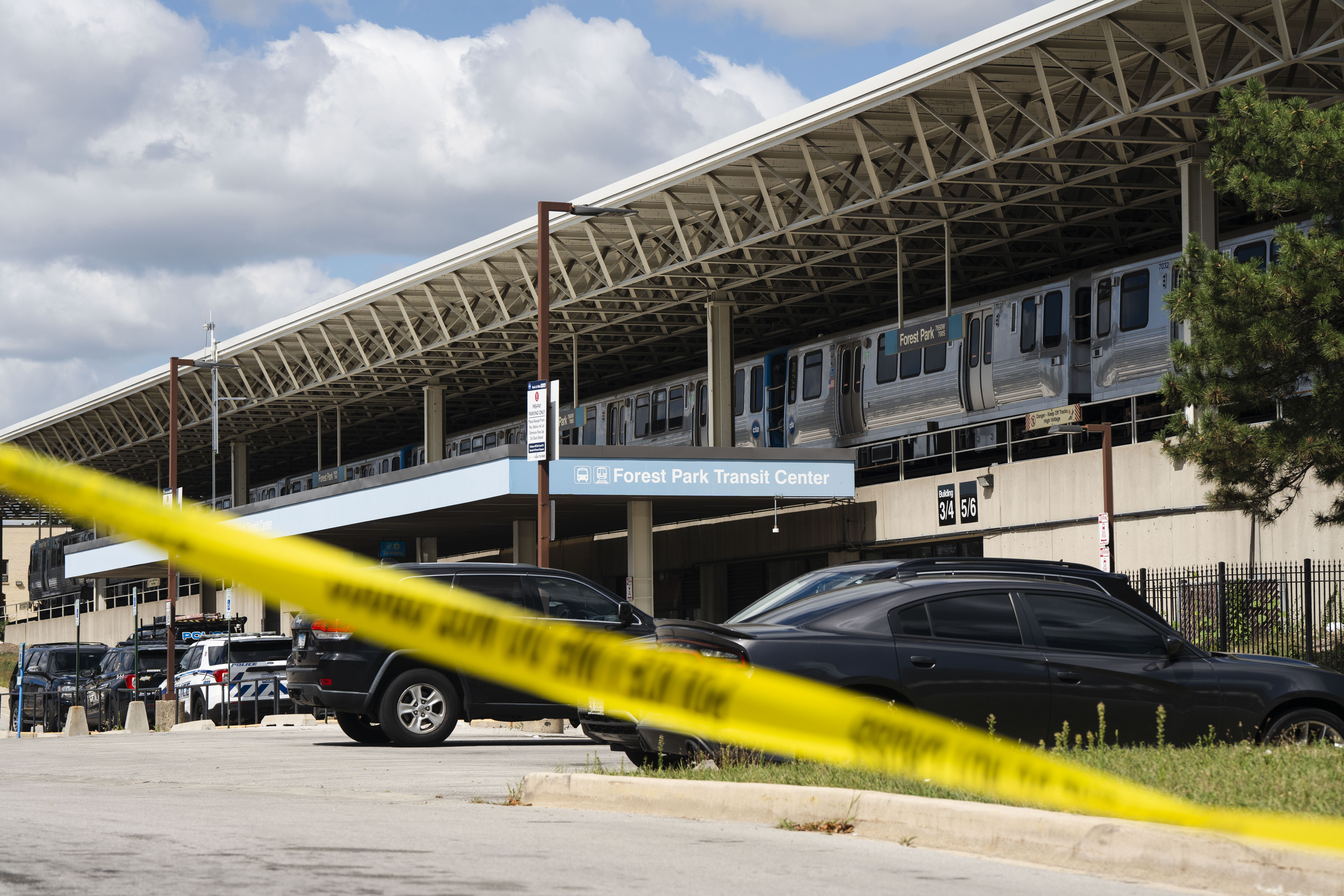 Yellow tape blocks off the parking lot of the Forest Park Blue Line train station in Forest Park after four people were fatally shot on the train early on Labor Day.