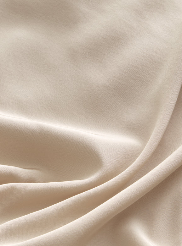 Close-up view of a draped fabric with soft folds.