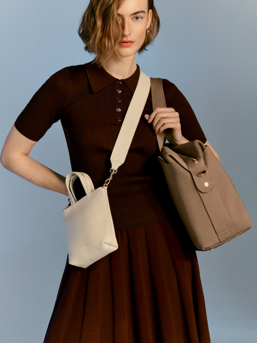 Woman holding two handbags