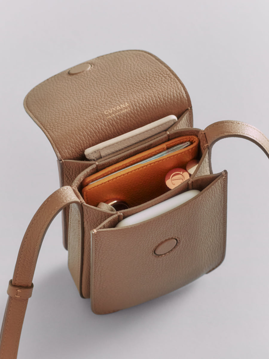 Open handbag with visible wallet and notebook inside.