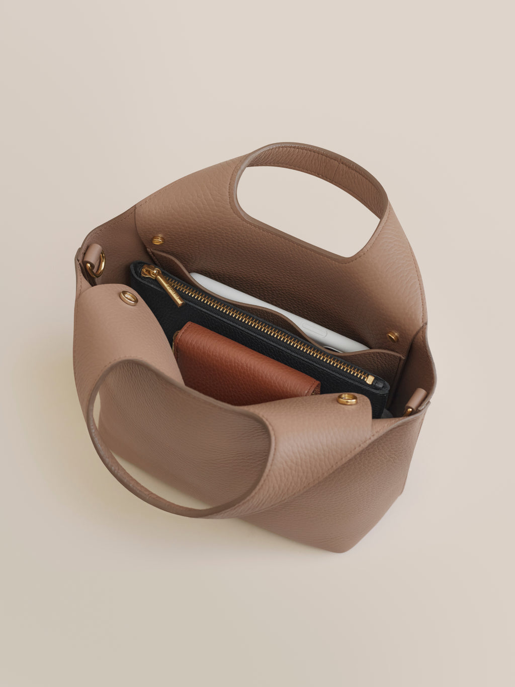 Handbag with zipper compartment visible.