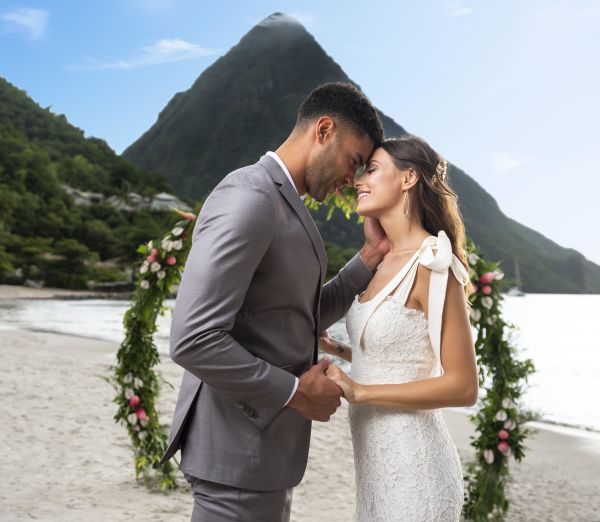 A Man And Woman Kissing On A Beach