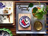 coffee table tray with blue and white dish plant and brass keys and brass bowl