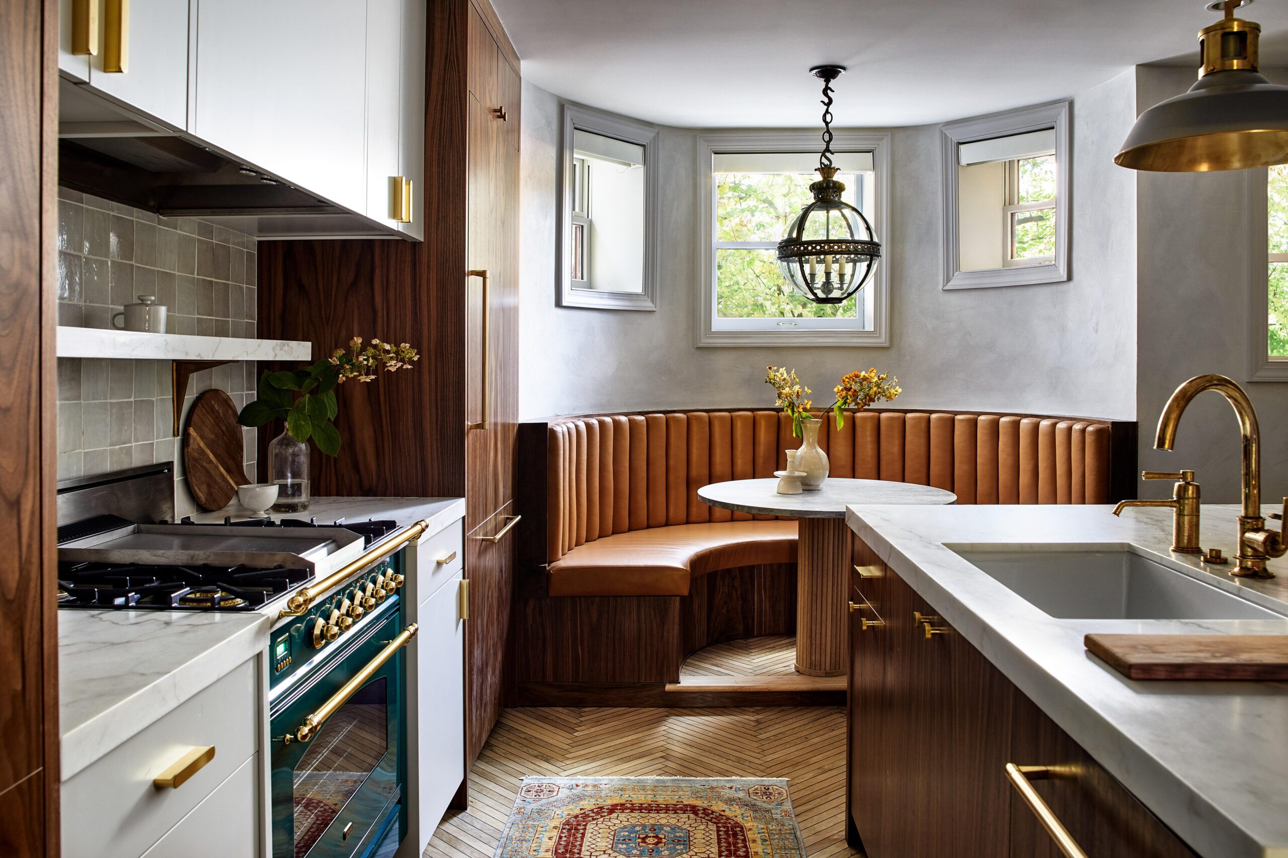 Gray kitchen with half circle cognac leather banquette