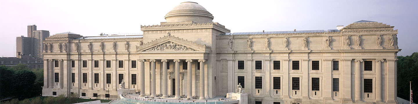 Daytime view of the front of the Brooklyn Museum building, taking in the entire facade