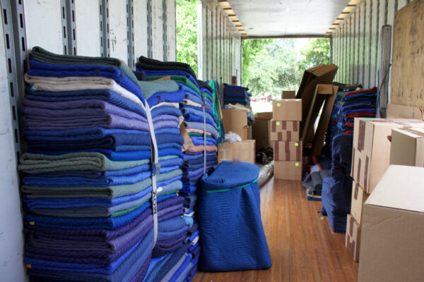 moving truck stacked with boxes and packing blankets