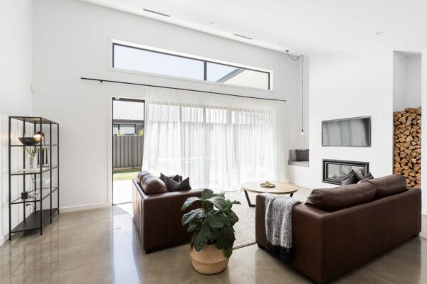 luxury living room with glass sliding doors and polished concrete floor