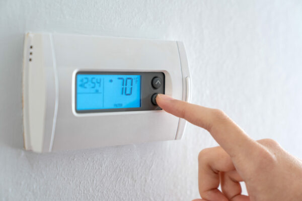 wall attached thermostat with a digital display