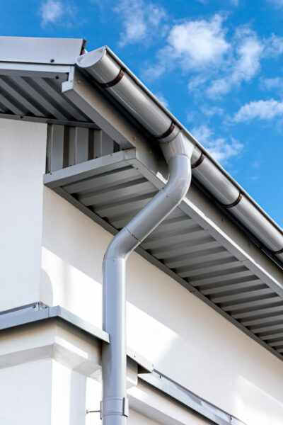 gray metal rain gutter on house rooftop