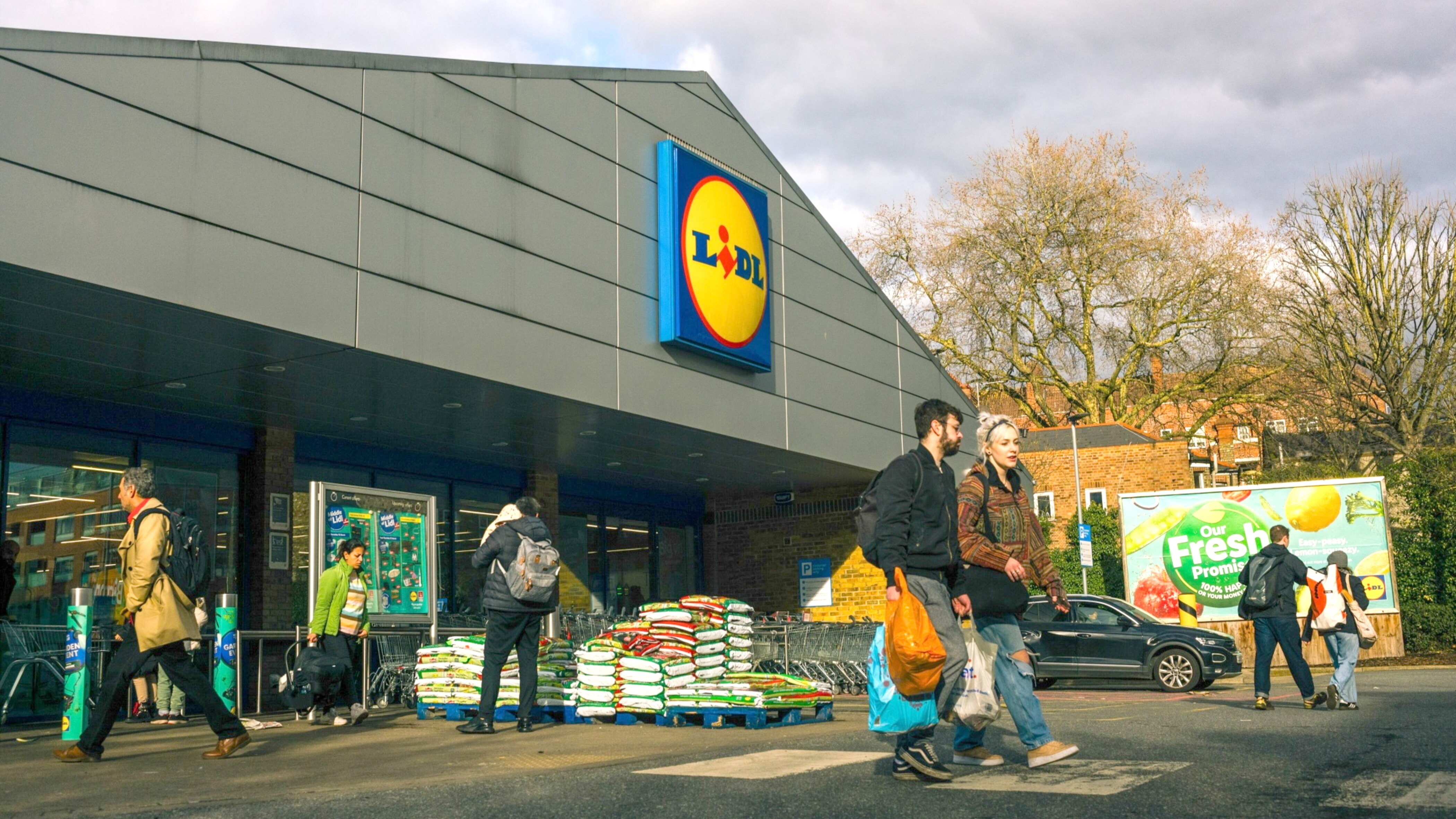 Shoppers leave a Lidl supermarket in London