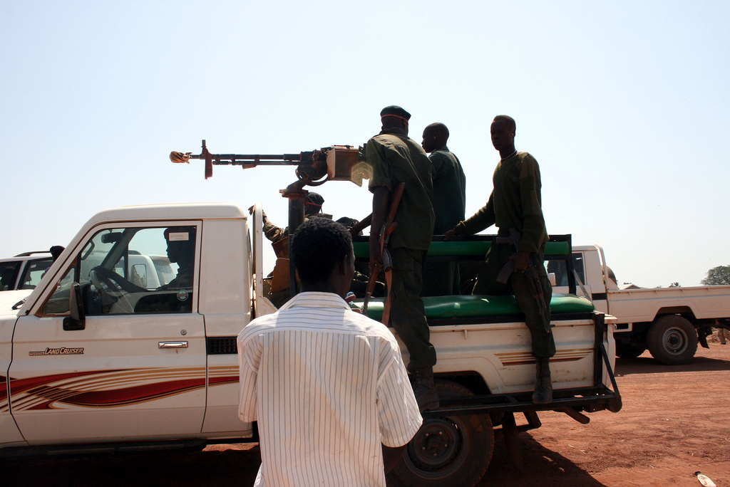 Paramilitary members ride in the back of a pickup truck in Warab state in southern Sudan. Photo by Larisa Epatko