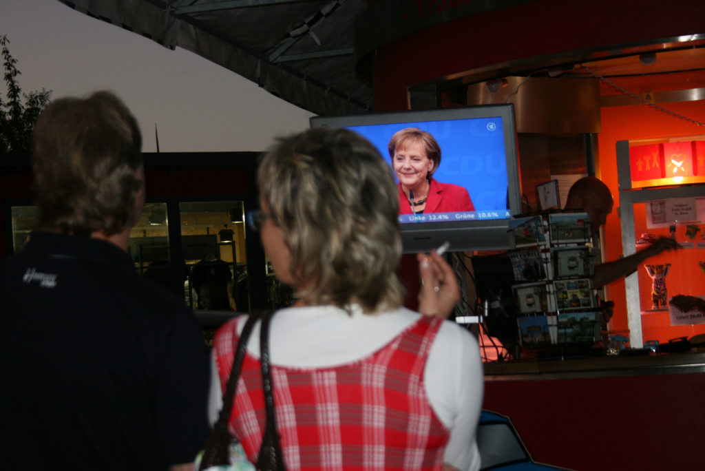 Germans watch Chancellor Angela Merkel on an outdoor television in September 2009. Photo by Larisa Epatko/PBS NewsHour