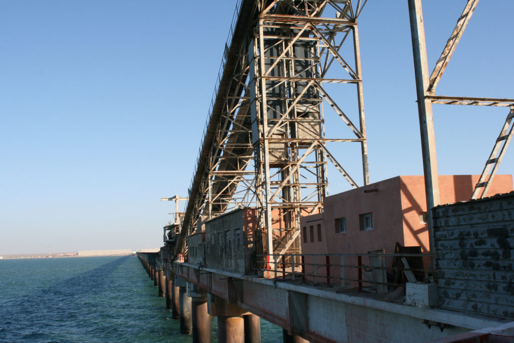 A conveyor belt carries phosphate rock to waiting ships at the Laayoune port. Photo by Larisa Epatko