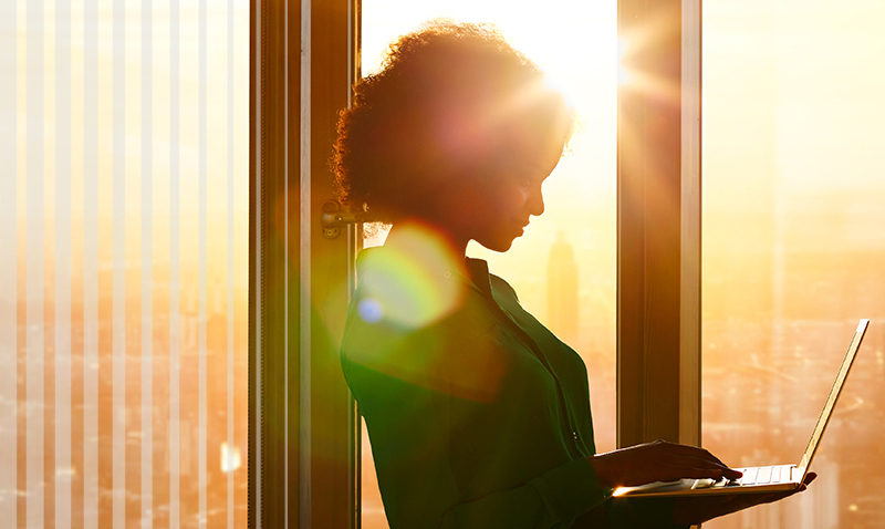 Woman with laptop in corporate environment