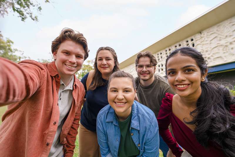 Group of students on campus at CQU smiling and looking at the camera.