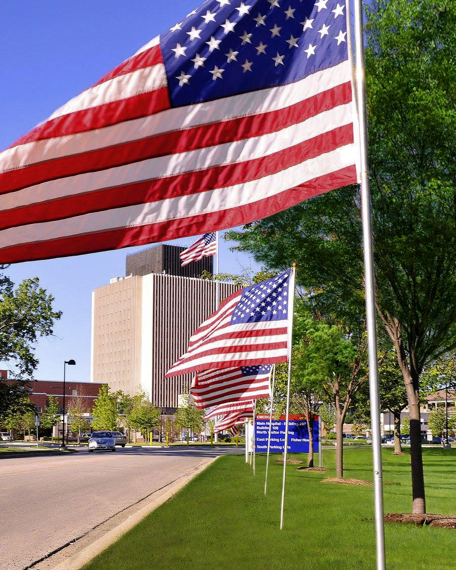 VA Medical center in the background with US flags lining the road.